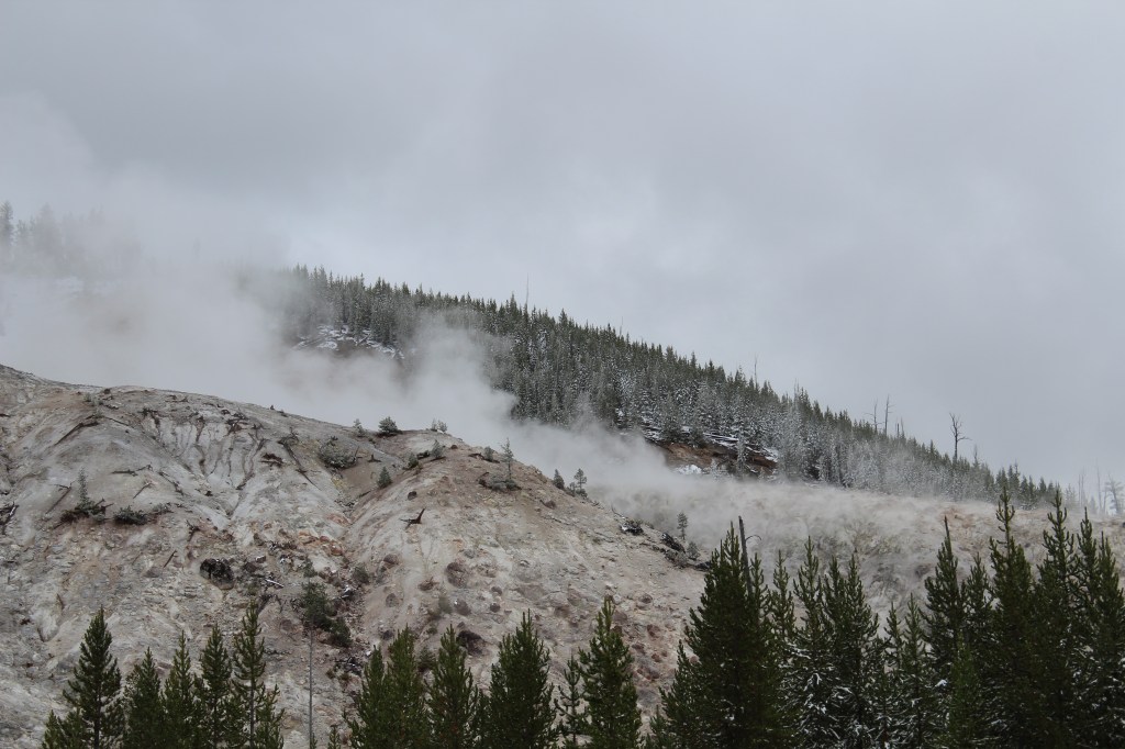 picture of a mountain with some steam coming out 