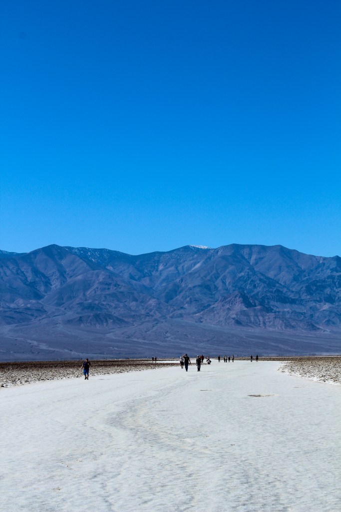 people walking on the salt flats at Badwater Basin